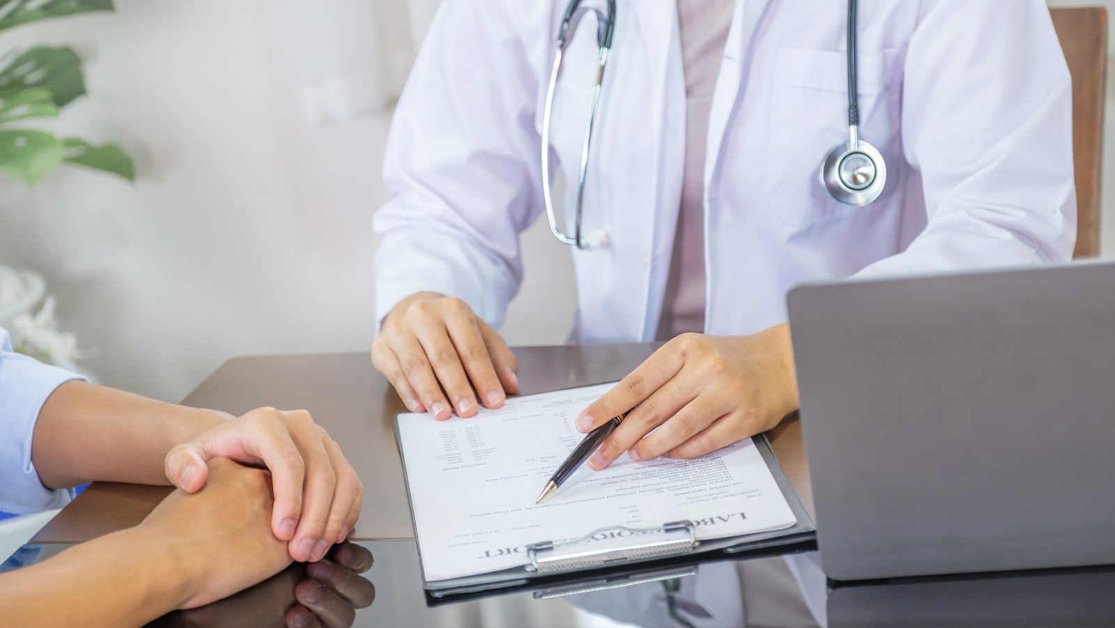 A physician reviewing a written care plan with a patient