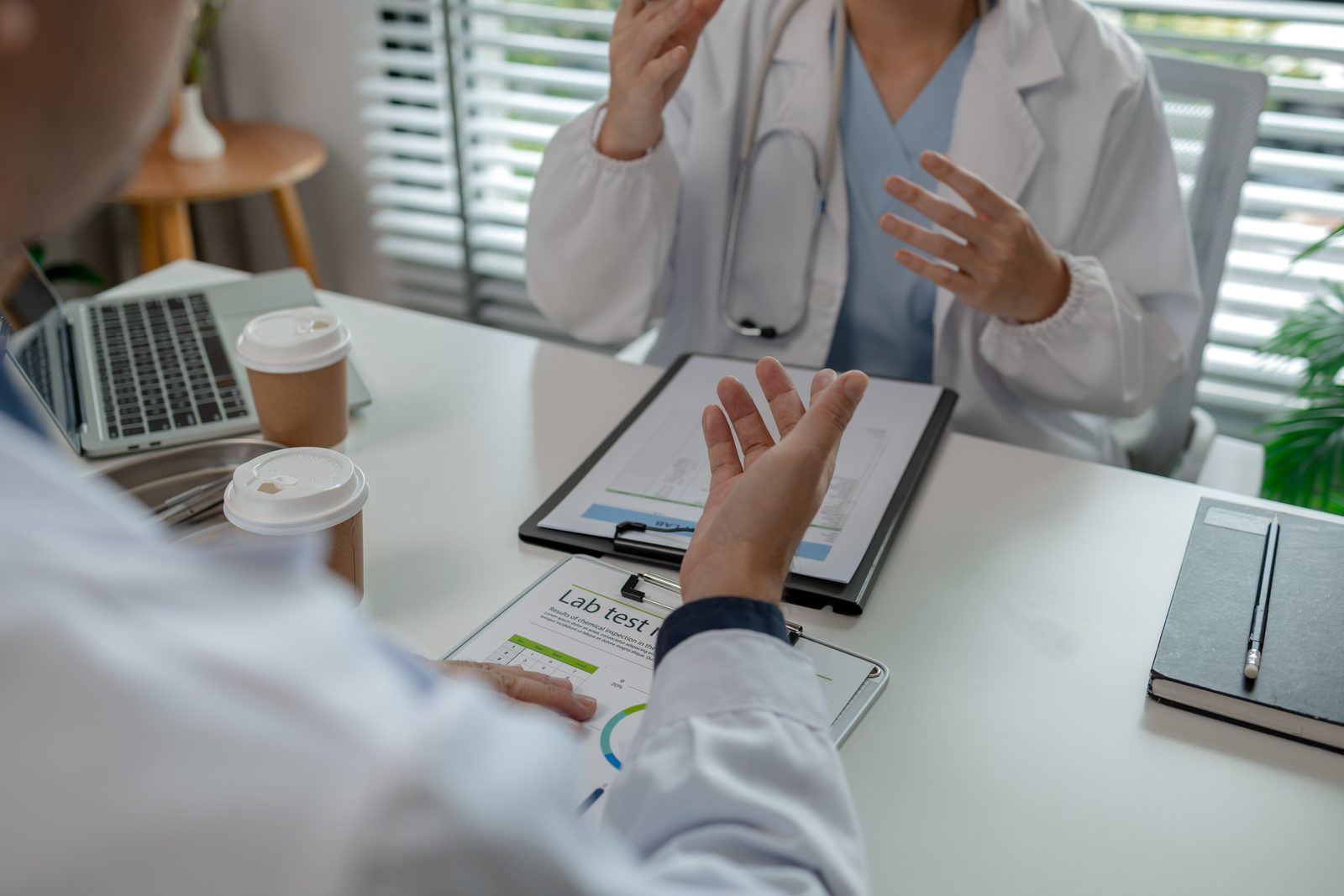 Two clinicians reviewing test results during a care handoff