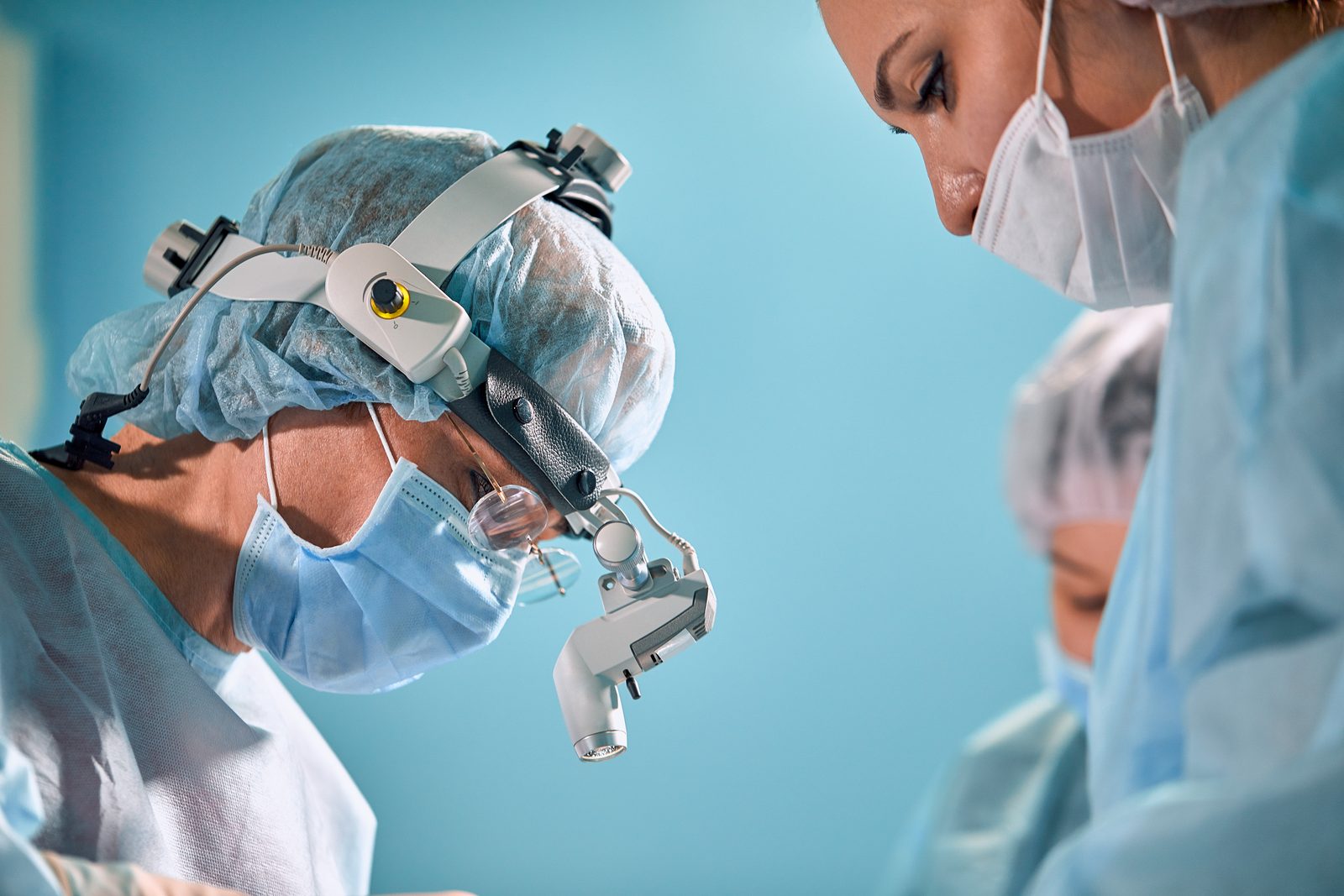 Two surgeons wearing magnifying loupes during an operation